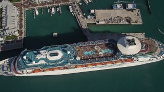 AX0027_018 - 5K aerial stock footage of approaching Royal Caribbean Cruise Ship docked, tilt down, Key West, Florida