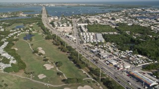 AX0027_031 - 5K aerial stock footage of following Overseas Highway through Stock Island, Key West, Florida