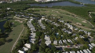 AX0027_032 - 5K aerial stock footage of flying by neighborhood, Key West Golf Club, Stock Island, Key West, Florida