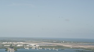 AX0027_033 - 5K aerial stock footage of tracking four F-18s in flight above Naval Air Station Key West, Key West, Florida