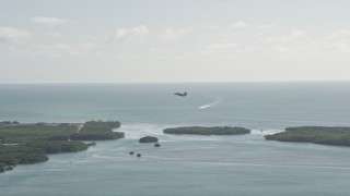 AX0027_037 - 5K aerial stock footage of tracking an F-18 landing at Naval Air Station Key West, Key West, Florida