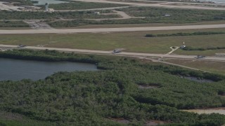 AX0027_040 - 5K aerial stock footage of tracking F-18s taxiing on the runway, Naval Air Station Key West, Key West, Florida