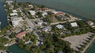 AX0027_049 - 5K aerial stock footage of flying over residential neighborhood, tilt down, Lower Sugarloaf Key, Florida