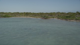AX0027_054E - 5K aerial stock footage of following the shore of Upper Sugarloaf Key, Florida, fly over mangroves