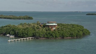AX0027_067 - 5K aerial stock footage of flying by small island with a home, Summerland Key, Florida