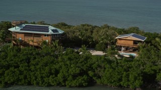 AX0027_068E - 5K aerial stock footage of a small island with a home, Summerland Key, Florida
