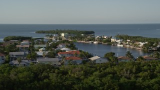 AX0028_001 - 5K stock footage aerial video of flying by homes near the shore, Marathon, Florida