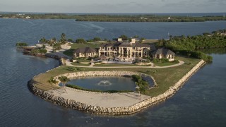 AX0028_004 - 5K stock footage aerial video of orbiting mansion on the shore, Marathon, Florida