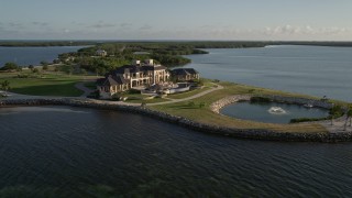 AX0028_005 - 5K stock footage aerial video of orbiting a mansion on the shore, Marathon, Florida