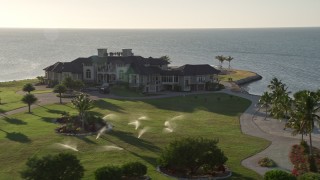 AX0028_006 - 5K aerial stock footage of circling a mansion on the shore, Marathon, Florida
