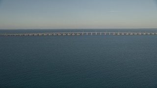 AX0028_019 - 5K aerial stock footage of approaching bridge at sunset on Overseas Highway, Long Key, Florida