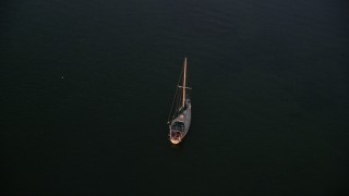 AX0028_035 - 5K aerial stock footage of approaching sailboat at sunset, Key Largo, Florida