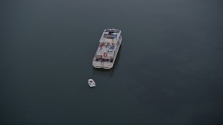 AX0028_040 - 5K aerial stock footage of orbiting a houseboat near shore at sunset, Key Largo, Florida