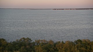 AX0028_041 - 5K aerial stock footage of flying over mangroves and a bay at sunset, Key Largo, Florida
