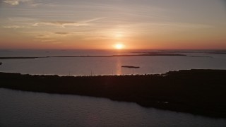 AX0028_042 - 5K aerial stock footage of flying by bays and mangroves, Key Largo, Florida, sunset