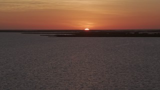 AX0028_047 - 5K aerial stock footage of ascending over the water, Key Largo, Florida, sunset
