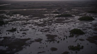 AX0028_054 - 5K aerial stock footage of flying by wetlands, Southern Glades, Florida, twilight