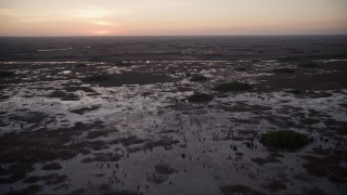 AX0028_055 - 5K aerial stock footage of flying by wetlands, Southern Glades, Florida, twilight