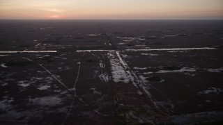 AX0028_056 - 5K aerial stock footage of flying by wetlands, Southern Glades, Florida, twilight