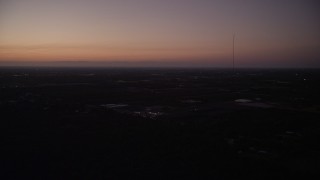 AX0028_063 - Aerial stock footage of 5K aerial  video of flying by Homestead, with coastline in distance, Homestead, Florida, twilight