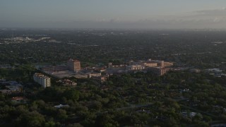 AX0029_002 - 5K aerial stock footage of flying by Baptist Hospital of Miami, Kendall, Florida, sunrise