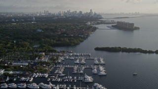 AX0029_007 - 5K aerial stock footage fly over marinas, Downtown Miami skyline, Coconut Grove, Florida, sunrise
