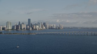 AX0029_011 - 5K aerial stock footage of downtown skyline, Rickenbacker Causeway bridge, Miami, Florida, sunrise