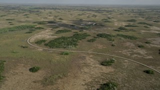 AX0030_056E - 5K aerial stock footage of flying by a winding country road, Florida Everglades, Florida