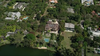 AX0031_005 - 5K aerial stock footage of approaching mansion, tilt down, Coral Gables, Florida
