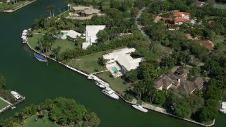 AX0031_006 - 5K aerial stock footage fly over canals, tilt down to mansion on shore, Coral Gables, Florida