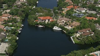 AX0031_008 - 5K aerial stock footage of flying by mansions near canal, Coral Gables, Florida