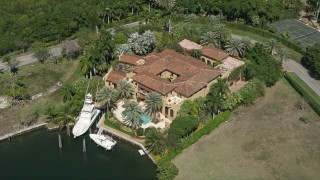 AX0031_011 - 5K aerial stock footage of a mansion near canal, Coral Gables, Florida