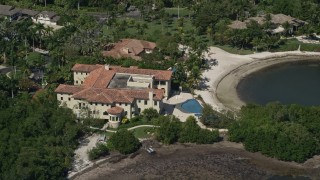 AX0031_012 - 5K aerial stock footage of flying by a mansion by a canal, Coral Gables, Florida