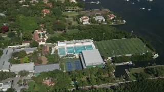 AX0031_014 - 5K aerial stock footage approach Ransom Everglades School, sports fields, pools, Coconut Grove, Florida