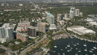 AX0031_015 - 5K aerial stock footage of flying by office buildings, Coconut Grove, Florida