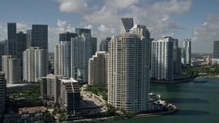 AX0031_025E - 5K aerial stock footage of flying by Brickell Key, Downtown Miami skyscrapers, Miami, Florida