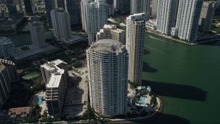 AX0031_037 - 5K aerial stock footage of flying by skyscrapers on the shore of Brickell Key, Downtown Miami, Florida