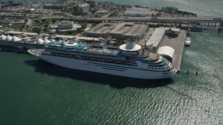 AX0031_040 - 5K aerial stock footage of orbiting a cruise ship docked, Port of Miami, Florida 