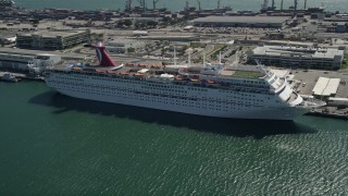 AX0031_042 - 5K aerial stock footage of a Carnival Cruise Ship at Port of Miami, Florida