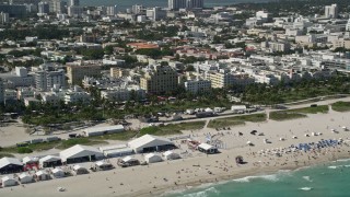 AX0031_053 - 5K aerial stock footage of flying by sunbathers on the beach, South Beach, Miami Beach, Florida