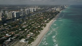 AX0031_086E - 5K aerial stock footage of approaching residential neighborhood on the shore, Golden Beach, Florida