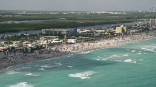 AX0031_094 - 5K aerial stock footage of flying by people at the beach, Hollywood, Florida