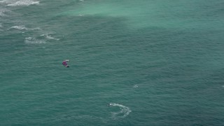 AX0031_097 - 5K aerial stock footage track a kite surfer near the coast, Hollywood, Florida