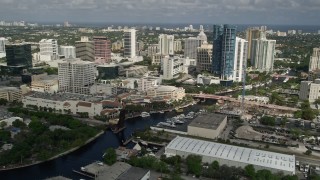 AX0031_118E - 5K stock footage aerial video of flying over the New River and Downtown Fort Lauderdale, Florida