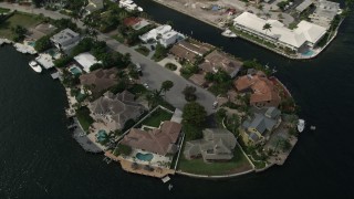 AX0031_139 - 5K aerial stock footage of approaching mansions by canals, tilt down, Fort Lauderdale, Florida