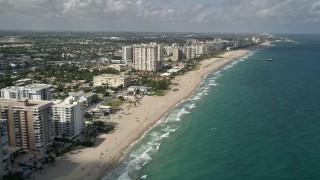 AX0031_151E - 5K aerial stock footage of following the beach along the coast, Pompano Beach, Florida