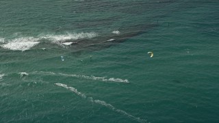 AX0031_155 - 5K aerial stock footage of flying by kite surfers off the coast, Pompano Beach, Florida