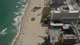 AX0031_178 - 5K stock footage aerial video of bird's eye view of sunbathers, Lighthouse Cove Resort, Pompano Beach, Florida