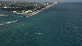 AX0031_181 - 5K aerial stock footage of flying over kite surfers near Hillsboro Inlet Light, Hillsboro Beach, Florida