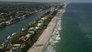 AX0032_009 - 5K aerial stock footage of flying by homes near the beach, revealing coastline, Hillsboro Beach, Florida